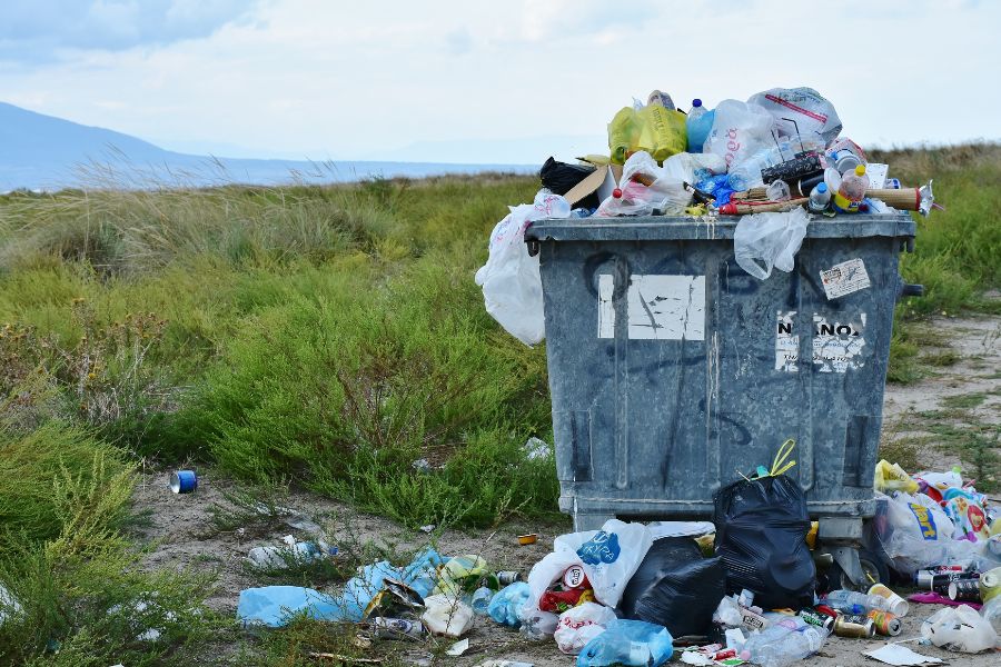 trash can overflowing with plastic
