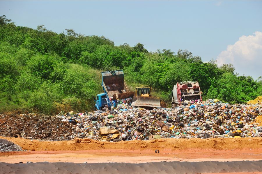 trucks dumping in a landfill