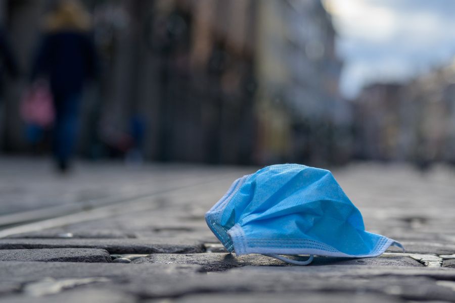 a discarded face mask on the street